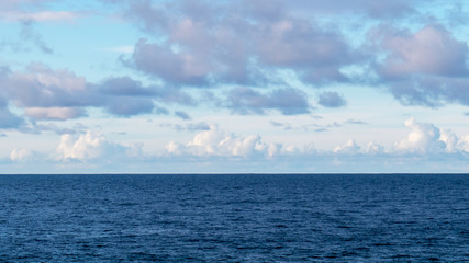 The flat horizon with clouds over the Atlantic Ocean during a beautiful day in Puerto Plata, Dominican Republic.