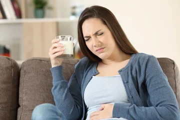 Fotobehang Woman suffering lactose intolerance © Antonioguillem