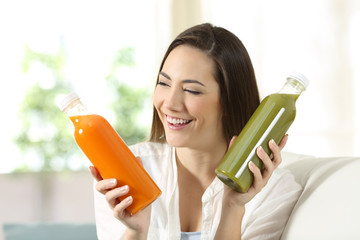 Woman comparing two vegetable juices