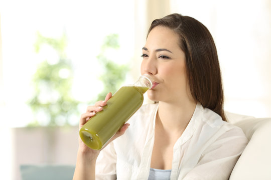 Woman Drinking A Vegetable Juice From A Bottle