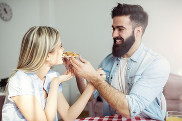 Couple eating pizza