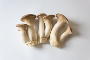 Three clusters of Pleurotus eryngii King Trumpet Mushrooms, isolated on white, centered, food ingredient, horizontal aspect