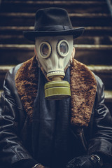Portrait of man with gas mask on the head,selective focus