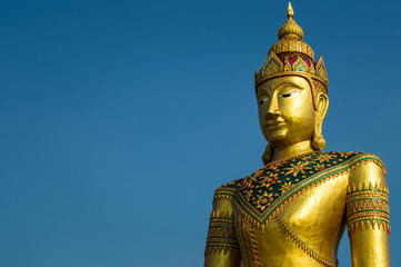 Golden image of buddha thai style on blue sky background