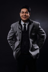 Obraz premium Portrait half body, Business Man Stand in gray coat white shirt black pants, studio