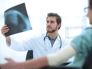 orthopedist examining a radiograph of a patient