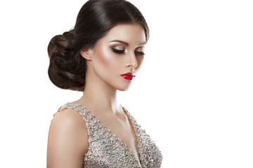 beauty fashion portrait of a beautiful model in an evening dress embroidered with stones.