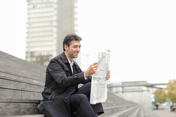 effect. Tutor dressed in gray coat sitting on rung and read morning newspaper. Articles pleased man...