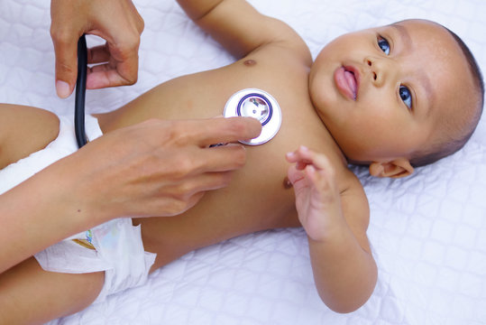 Doctor Using A Stethoscope To Listen To Baby's Chest , Baby Health Concept