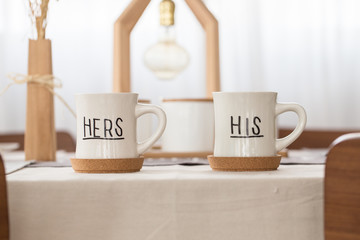 couple Coffee cups his and her on dining table