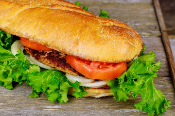 Chickenburger chicken burger hamburger tomatoes lettuce cheese wooden board wood
