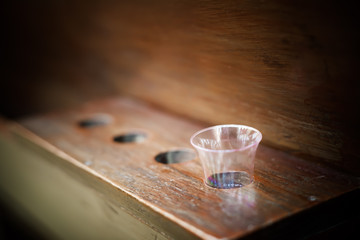 Glass placed on a wooden chair in the church.