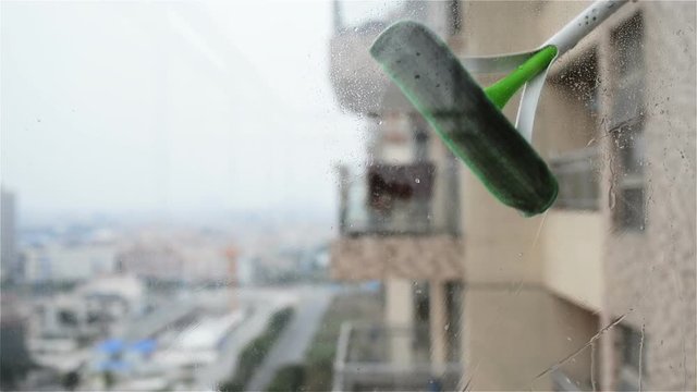 Cleaning glass window in an apartment