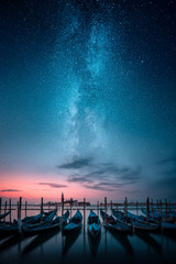 Gondolas in a row and Chiesa di San Giorgio Maggiore in background against milky way on the sky - obrazy, fototapety, plakaty
