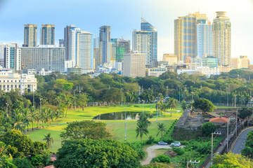 Manila city skyline in Philippines. Ermita and Paco districts seen from Intramuros. - obrazy, fototapety, plakaty