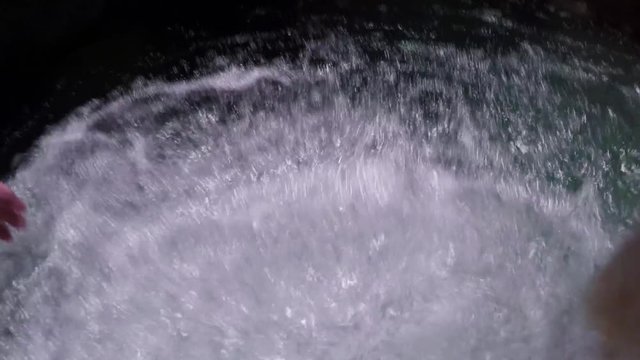 POV of a man swimming into a cave in a canyoning adventure in Cebu, Philippines