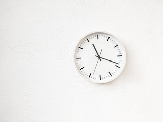 Simple modern round clock on white wall