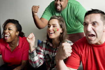 Friends cheering world cup with painted flag