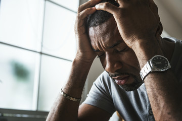 Black guy stressting and headache - Powered by Adobe