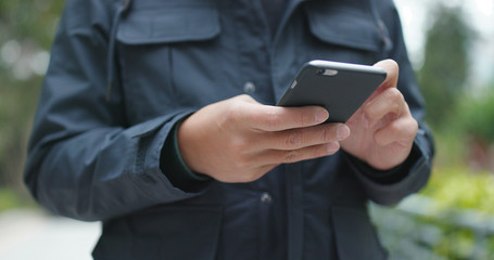 Man use of smart phone at outdoor winter time
