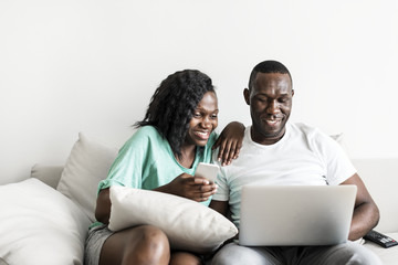 Black couple using digital devices