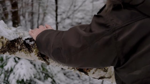 Man removes snow by hand with tree - (4K)