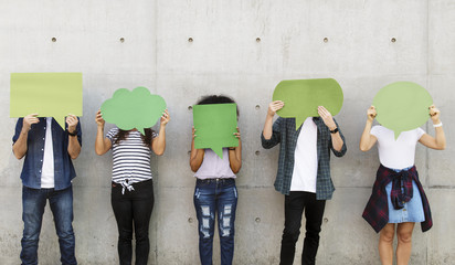 Group of young adults outdoors holding empty placard copyspace thought bubbles