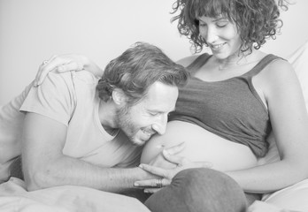 Husband kissing baby bump