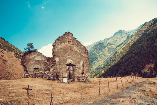 Remains of old ruined church, Dartlo village. Adventure holiday in Tusheti. Travel to Georgia. Mount landscape. Green ecology tourism. Countryside nature. Copyspace. Eco trekking tour. Dirt road
