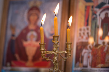 candle against the background of orthodox icons