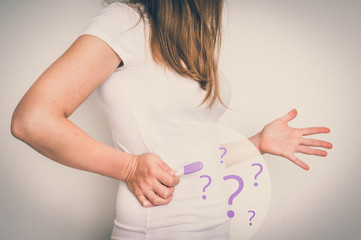 Woman with imagination of a pregnant belly - infertility concept