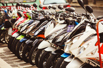 mopeds parked at the porch. rent and hire scooters.