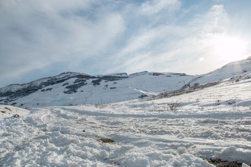 Panoramic view of mountain winter landscape with snowy peak.