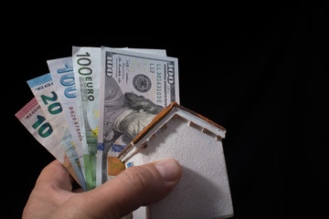 Hand holding American dollar  isolated on black background