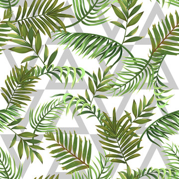 Seamless pattern with leaves of tropical palms and triangles