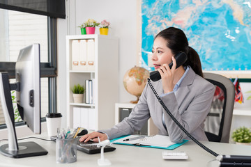 beautiful female office worker looking at computer