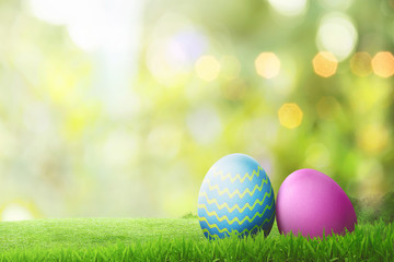 Two easter eggs on green grass lawn