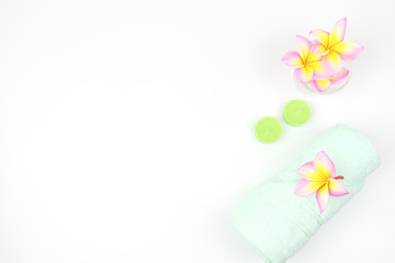 green spa towel on the table. towel with pink rose flower on the table.flat ray. top view .accessories for spa set