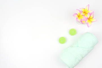 green spa towel on the table. towel with pink rose flower on the table.flat ray. top view .accessories for spa set