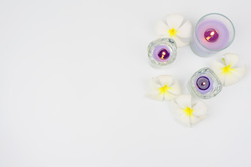 Background spa set.candle and plumeria flower on white background.