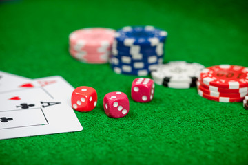 Dice on casino gamble table. Poker chips and banknotes on table in casino