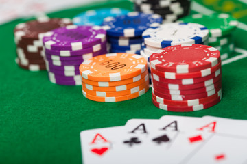 Poker chips on table in casino. Cards on green felt casino table