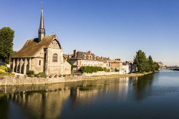The Catholic church of Saint-Maurice in Sens, Burgundy, France, reflected in the river Yonne