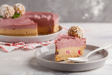 Pink berry caramel raw vegan cheesecake with coconut sweet raw balls. Healthy vegan food concept.
