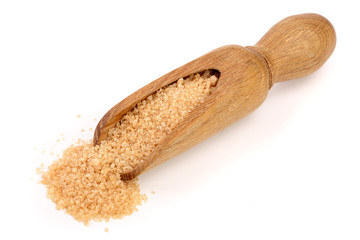 brown sugar in wooden scoop isolated on white background