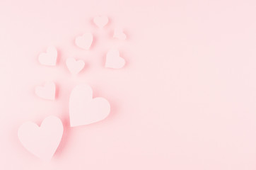 Valentines day background with hearts flying on pink paper, copy space.