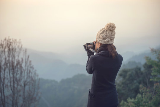 Traveler woman take photo view of mountain with mirrorless camera.