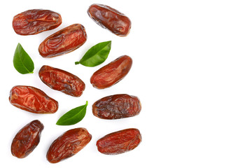 dry dates with green leaves isolated on white background with copy space for your text. Top view. Flat lay pattern