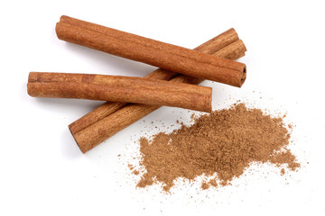 Cinnamon sticks with powder isolated on white background. Top view