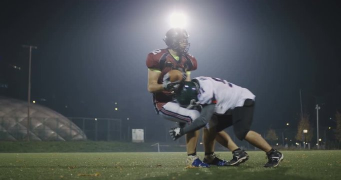 American football player tackles opponent